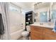 Bathroom featuring a shower-tub combo and a wood vanity with a mirror at 6270 Dartington Hall St, Henderson, NV 89011
