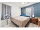 Bedroom featuring an accent wall, a window, and wood-look floors at 6270 Dartington Hall St, Henderson, NV 89011