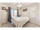Bright bedroom featuring a ceiling fan, wood floors, and a sliding door to the outside at 6270 Dartington Hall St, Henderson, NV 89011