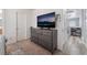 Bedroom featuring a gray dresser with a mounted TV and access to the hallway and ensuite bathroom at 6270 Dartington Hall St, Henderson, NV 89011