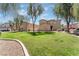 View of the townhome community, featuring mature trees, greenbelts and lush lawns at 6270 Dartington Hall St, Henderson, NV 89011