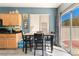 Dining area with slider to patio, in close proximity to the kitchen, and featuring gray plank flooring at 6270 Dartington Hall St, Henderson, NV 89011