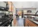Bright kitchen with wood cabinets, stainless steel appliances, and a dining area leading to the yard at 6270 Dartington Hall St, Henderson, NV 89011