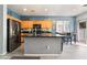 A well-lit kitchen features stainless steel appliances, light oak cabinets, and a center island at 6270 Dartington Hall St, Henderson, NV 89011