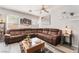 Bright living room with a large sectional sofa, plank flooring, and modern decor at 6270 Dartington Hall St, Henderson, NV 89011