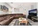 Spacious living room featuring gray plank flooring, comfortable seating, and bright, neutral paint at 6270 Dartington Hall St, Henderson, NV 89011