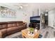 Cozy living room with comfortable brown sofa, modern decor, and natural light at 6270 Dartington Hall St, Henderson, NV 89011