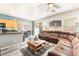 Living room area with gray plank flooring flowing to the kitchen, which includes an eat-in dining space at 6270 Dartington Hall St, Henderson, NV 89011