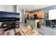 Open-concept space with gray plank flooring connecting the living and dining areas to the kitchen at 6270 Dartington Hall St, Henderson, NV 89011
