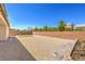 Large backyard featuring low maintenance gravel landscaping, a small turf area, and brick walls at 6280 Lamont Hills Ave, Las Vegas, NV 89139