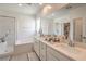 Bright bathroom with double sinks, shower, and bathtub at 6280 Lamont Hills Ave, Las Vegas, NV 89139