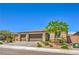 Charming single-story home with a three-car garage, desert landscaping and stone accents at 6280 Lamont Hills Ave, Las Vegas, NV 89139