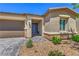 Attractive home featuring a stone veneer accent, covered entry and a three car garage at 6280 Lamont Hills Ave, Las Vegas, NV 89139