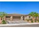 Charming single-story home with a three-car garage, desert landscaping and stone accents at 6280 Lamont Hills Ave, Las Vegas, NV 89139