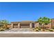Charming single-story home with a three-car garage, desert landscaping and stone accents at 6280 Lamont Hills Ave, Las Vegas, NV 89139