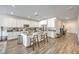 Open kitchen with large island, stainless steel appliances, white cabinets and wood floors at 6280 Lamont Hills Ave, Las Vegas, NV 89139