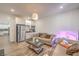 Cozy living space with modern kitchenette featuring stainless steel refrigerator and white cabinets at 6280 Lamont Hills Ave, Las Vegas, NV 89139