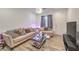 Inviting living room featuring comfortable seating, modern decor, and sleek floors at 6280 Lamont Hills Ave, Las Vegas, NV 89139
