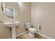 Cozy powder room features a pedestal sink and tile flooring at 6417 Giant Oak St, North Las Vegas, NV 89084