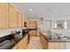 Well-lit kitchen featuring modern stainless steel appliances and a breakfast bar at 6417 Giant Oak St, North Las Vegas, NV 89084