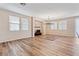 Well-lit living room featuring hardwood floors, neutral walls, and a modern chandelier at 6417 Giant Oak St, North Las Vegas, NV 89084