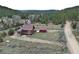 Aerial view of a cozy cabin and detached garage on a sprawling lot, embraced by natural beauty at 660 E Aspen Meadow Dr, Mammoth Creek, UT 84735