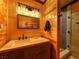 Bathroom vanity with rustic finishes, decorative lighting, and walk-in shower at 660 E Aspen Meadow Dr, Mammoth Creek, UT 84735
