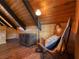 Attic bedroom features a decorative trunk, stylish leather chair and hardwood floors at 660 E Aspen Meadow Dr, Mammoth Creek, UT 84735