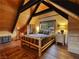 Comfortable bedroom with hardwood floors, wood-paneled walls, and a cozy double bed with mountain-themed bedding at 660 E Aspen Meadow Dr, Mammoth Creek, UT 84735