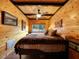 Bedroom with wood-paneled walls, ceiling fan, and large window with view at 660 E Aspen Meadow Dr, Mammoth Creek, UT 84735