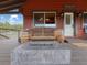 Inviting covered porch with stylish seating and a cozy fire pit, perfect for outdoor relaxation and entertaining at 660 E Aspen Meadow Dr, Mammoth Creek, UT 84735