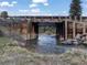 Scenic view of a wooden bridge over a creek, enhancing the natural beauty of the property at 660 E Aspen Meadow Dr, Mammoth Creek, UT 84735
