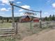 Welcoming entrance with a custom 'Whiskey River' sign and rustic wooden gate, leading to the property at 660 E Aspen Meadow Dr, Mammoth Creek, UT 84735