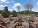 Picturesque outdoor fire pit surrounded by Adirondack chairs and natural landscaping, ideal for gatherings at 660 E Aspen Meadow Dr, Mammoth Creek, UT 84735