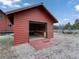 Exterior of a rustic garage with a wooden door, seamlessly blending functionality with natural surroundings at 660 E Aspen Meadow Dr, Mammoth Creek, UT 84735