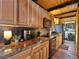 Modern kitchen with warm wooden cabinets, sleek black appliances, and stylish countertops at 660 E Aspen Meadow Dr, Mammoth Creek, UT 84735