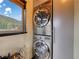 Modern laundry room featuring new stainless-steel washer and dryer next to a window with a mountain view at 660 E Aspen Meadow Dr, Mammoth Creek, UT 84735