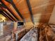 Bright living room featuring wood paneling, beamed ceilings, a sleeper sofa and a flat screen television at 660 E Aspen Meadow Dr, Mammoth Creek, UT 84735