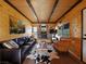 Cozy living room with wood paneled walls, leather furniture, and a brick fireplace at 660 E Aspen Meadow Dr, Mammoth Creek, UT 84735