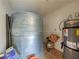 Functional utility room featuring a large water tank and a modern water heater system for efficient home management at 660 E Aspen Meadow Dr, Mammoth Creek, UT 84735