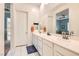 Modern bathroom with double sinks, large mirrors, white cabinets, and glass shower at 759 Praire Plume St, Henderson, NV 89011