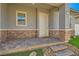 Covered front porch entry features stone brick flooring and supporting pillars; perfect for enjoying a cool drink on a summer day at 759 Praire Plume St, Henderson, NV 89011
