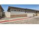 Exterior view of a gray home with a two-car garage and brick base at 759 Praire Plume St, Henderson, NV 89011