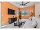 Bright living room features contemporary furnishings, ceiling fan, and large window letting in natural light at 759 Praire Plume St, Henderson, NV 89011