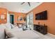 Open concept living room and dining area with a modern sofa and entertainment center at 759 Praire Plume St, Henderson, NV 89011