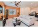 Open-concept living room boasts a modern ceiling fan, sleek tile flooring, and comfortable furniture at 759 Praire Plume St, Henderson, NV 89011