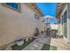 Backyard patio with pavers, gravel features, umbrella and outdoor sitting area at 759 Praire Plume St, Henderson, NV 89011