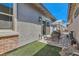 Cozy patio with pavers, artificial turf, umbrella and outdoor furniture at 759 Praire Plume St, Henderson, NV 89011