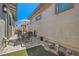 A charming patio with pavers, artificial turf, and an umbrella at 759 Praire Plume St, Henderson, NV 89011