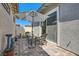 Private backyard patio with pavers, artificial turf, umbrella and sitting area at 759 Praire Plume St, Henderson, NV 89011